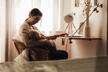 Woman working at home with her baby