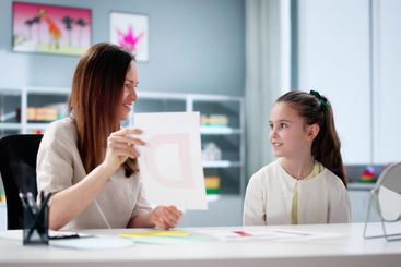 Child Speech Therapy: Woman Pathologist Helping Kids...