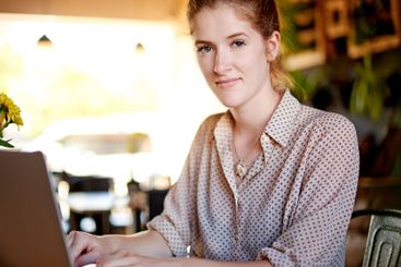 Laptop, portrait and woman in cafe with remote work,...
