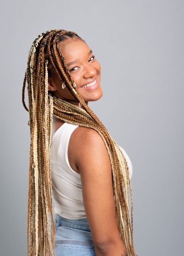 Beautiful brunette woman with braids in her hair wearing...