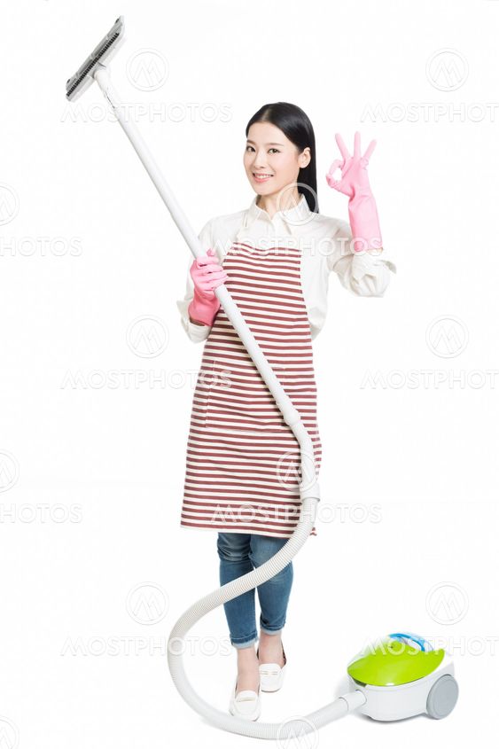 chinese young woman with a vacuum cleaner