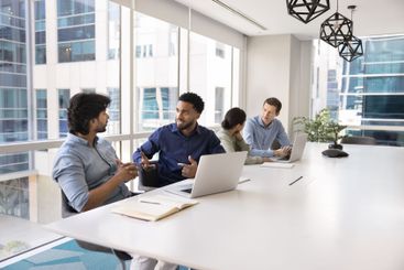 Diverse male project managers meeting in co-working space
