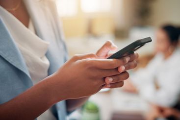 News, hands or businesswoman in office with mobile or...