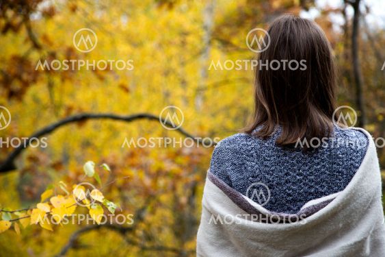 Rear view from the back of a girl in a gray dress who is...