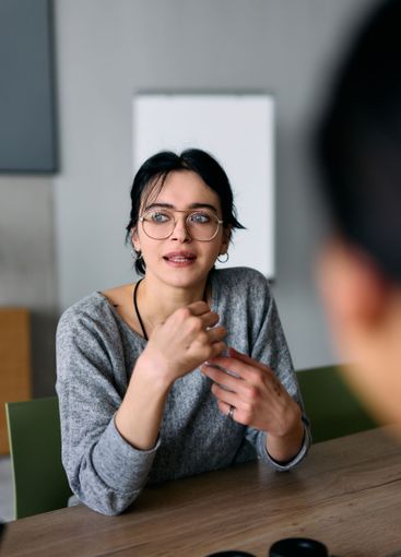 A close up portrait of a young businesswoman engaged in...