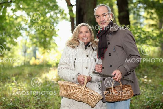Older couple picking mushrooms