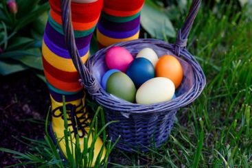 Close-up of legs of toddler girl with colorful stockings...