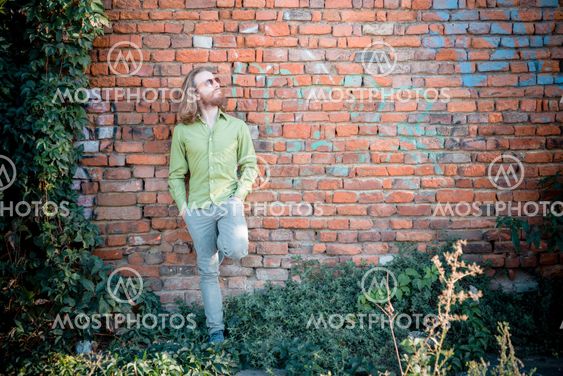 stylish hipster model with long red hair and beard lifestyle