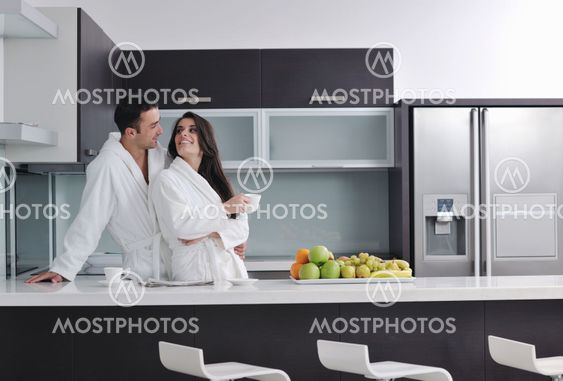 young couple have fun in modern kitchen