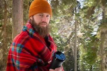 Winter season, snowy landscape adult man walking in the...