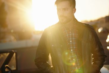 Thinking, relax or man at sunset in city to travel for...