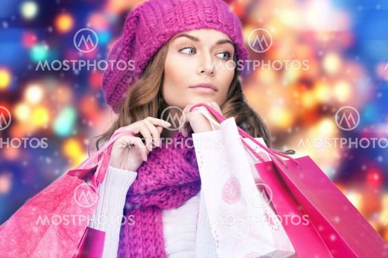 woman in winter clothes with pink shopping bags