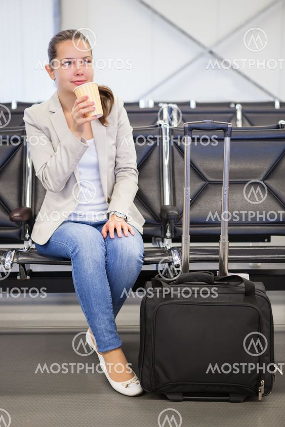 Businesswoman Having Coffee At Airport Lobby