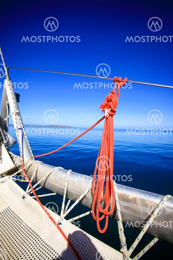 Bow of a sailing boat in calm blue sea