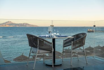 Luxury seaside dining at sunset, with beautifully...