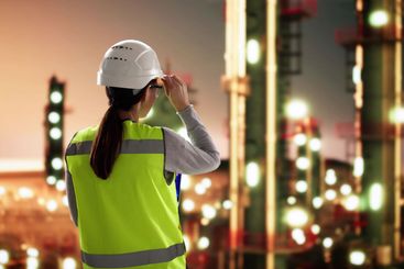 Female Engineer Analyzing Chemical Data on Laptop