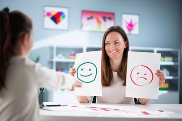 Helping a child with ADHD through therapy with a...