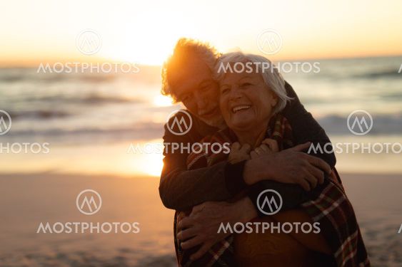 Old couple in love at the beach