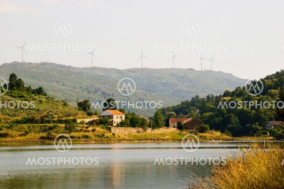 House at the lake with wind turbines