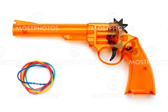 Toy plastic gun and elastic band , on a white background