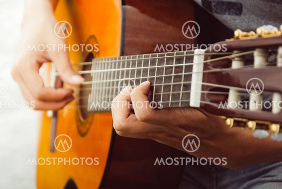 hand playing on guitar