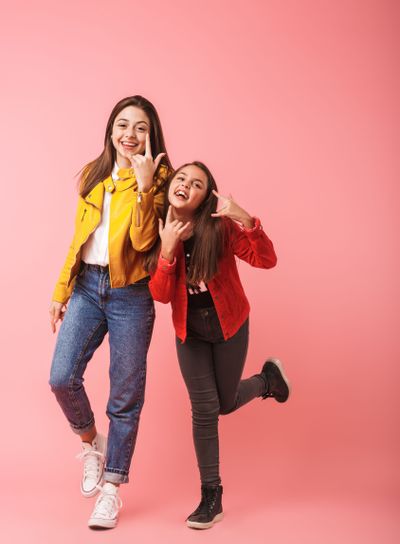 Full length photo of excited girls in casual standing...