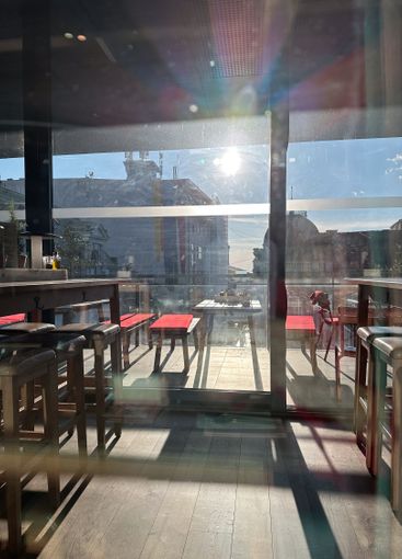 Sunlight streaming into a cozy cafe, highlighting the...