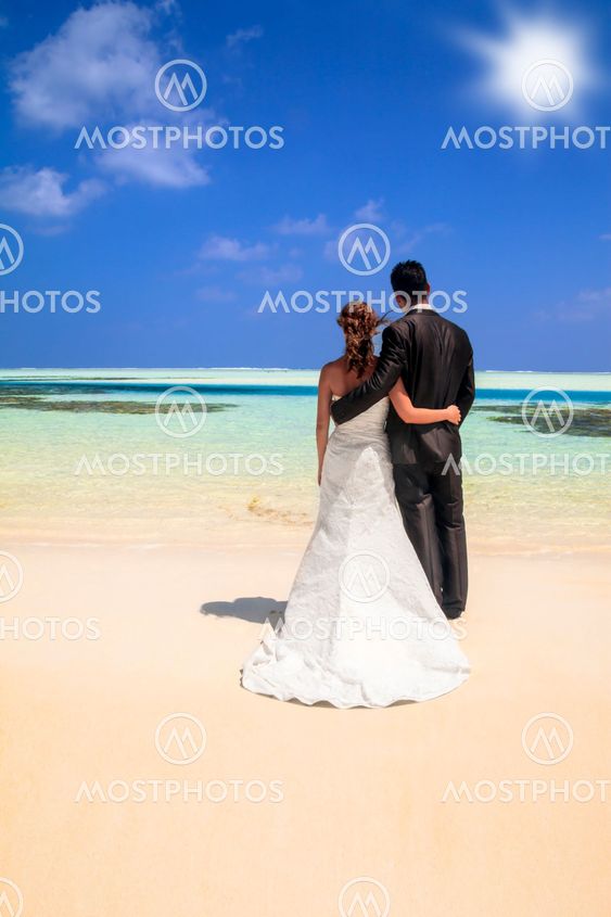 Bride and groom on idyllic tropical beach