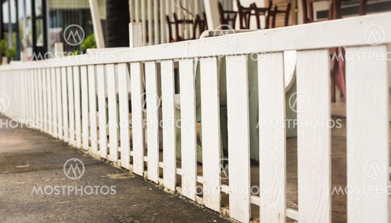 White wooden country style fence and small yard behind