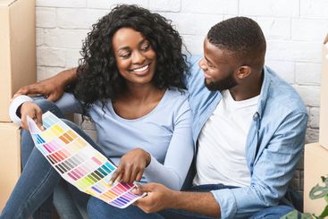 Just married couple choosing walls colour for new apartment