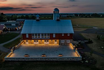 Dusk On Farm With Red Barn, Silo, And Illuminated Courtyard