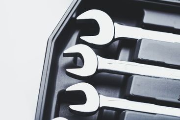 Set of shiny wrenches neatly arranged in a black tool...