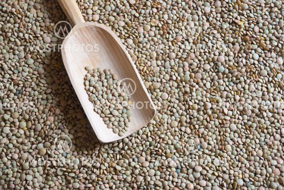 Raw lentil with wooden scooper