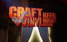 Craft beer and vinyl music festival signage with vibrant...