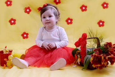 Baby girl anniversary in red and yellow decor