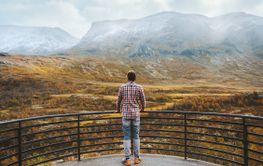 Traveler man in mountains of Norway autumn season travel