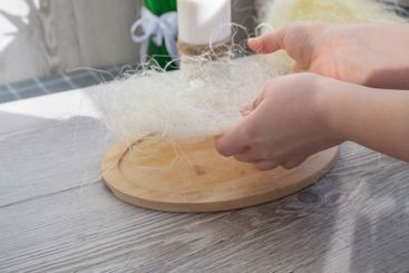 Unrecognizable woman creating Easter holiday decoration...