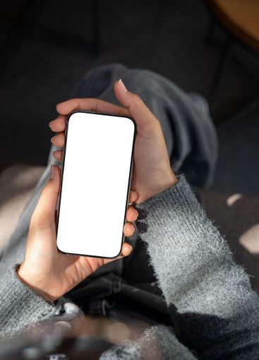 A close-up of a woman sitting indoors, sunlight...