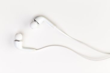 Pair of earphones close up on grey background