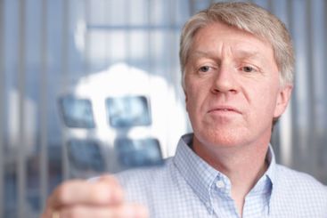 Mature, man and dentist with x ray scan for teeth...