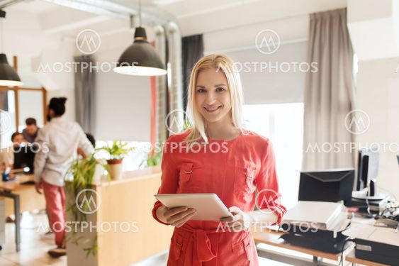 happy creative female office worker with tablet pc