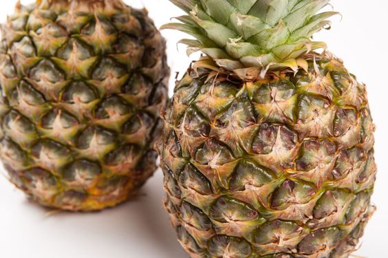 two big pineapples on a white background