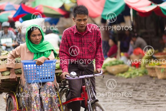 Burmese sellers riding bicycle