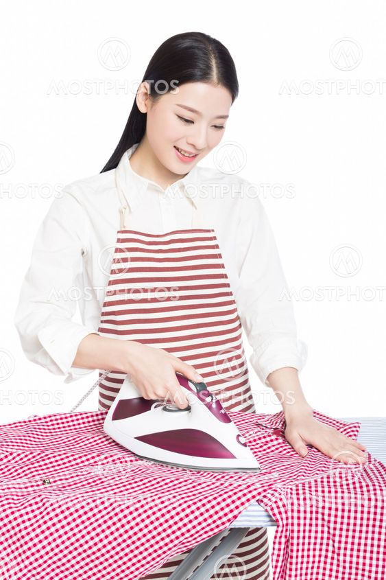 young housewife ironing