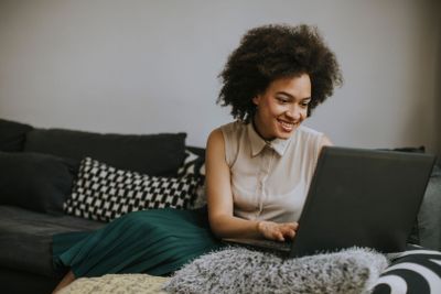 Attractive young woman working on laptop at home