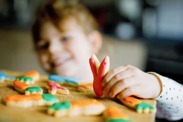 Cute little toddler girl and fresh baked homemade Easter...