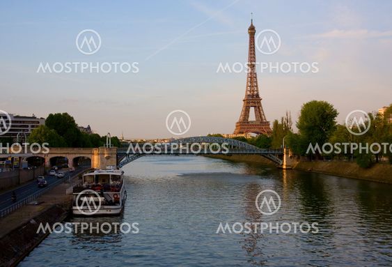 View of the Eiffel Tower and the Seine with a tourist boat