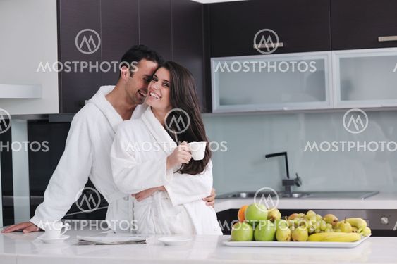 young couple have fun in modern kitchen