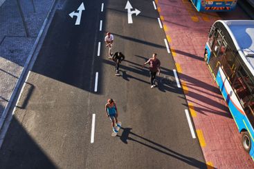 Group, skating and friends with skateboard, road and...