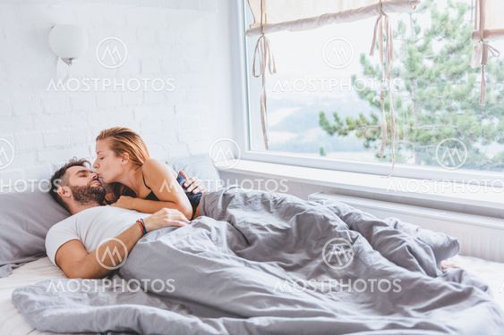 Young couple enjoying bed time in the morning